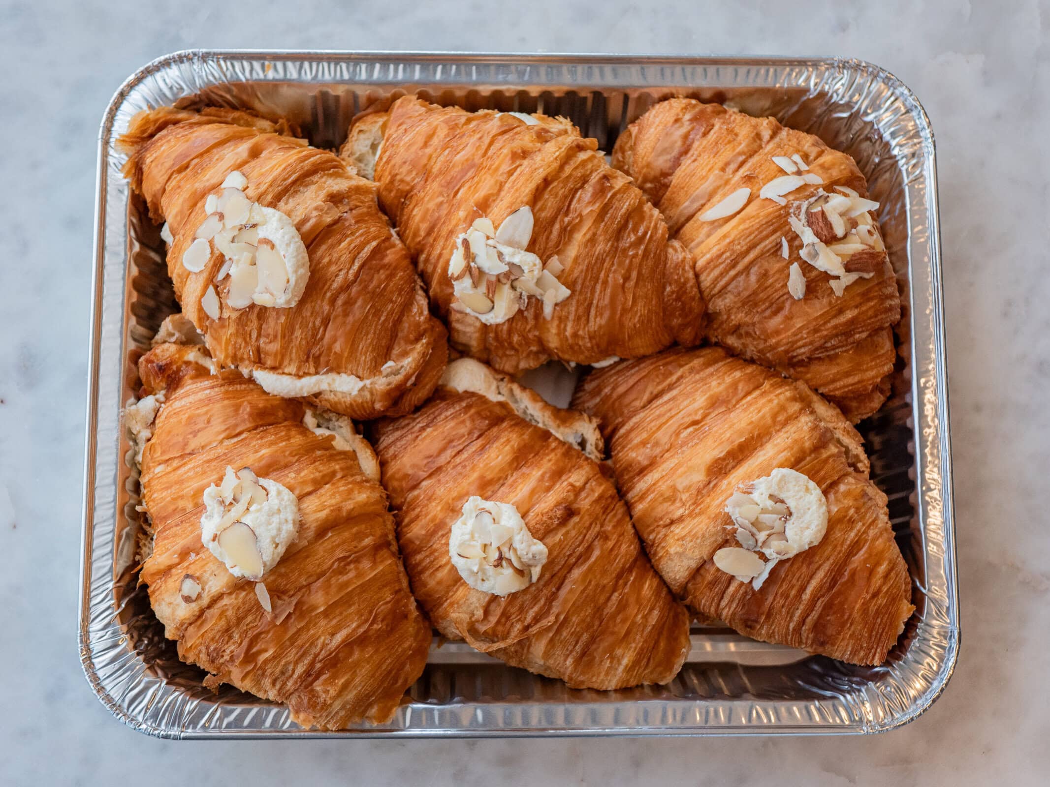 Classic Croissants - Bake At Home Collection The perfect collection for those who want to bake at home with the family, especially during the Holidays. Now you get to take home our classic items and bake them yourself. Fill your home with the smell of freshly baked french croissants. You will definitely feel like a French baker. No one needs to know they came from JL *wink wink. Our classic JL classic croissants are prepared with our house-made croissant dough. Our Bake at Home collection includes 6 raw almond croissants to be baked at home and instructions on how to bake properly. Items should be frozen upon receipt until ready to bake. The product can be moved into your own baking dish before baking. Tag us on Instagram with your baked croissants @JLPATISSERIEAZ! Happy Holidays from the JL team! *CONTAINS DAIRY, EGGS, AND WHEAT*