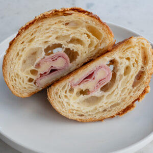 Our ham and cheese croissant is our house-made croissant dough, baked with ham, Swiss cheese, and bechamel sauce. Baked fresh daily.