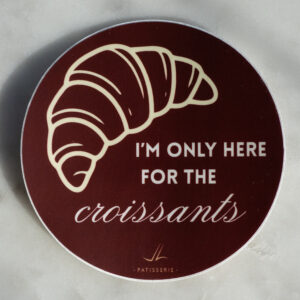 Bordeaux color sticker with a croissant and text "I'm only here for the croissants"